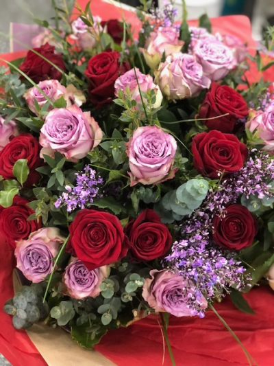 Garden Symphonie - A harmonious blend of roses in varying shades - this one in velvet red and romantic lilac - a dreamy alternative to The Classic Rouge, this bouquet is just perfect for truly heart-felt occasions.  Premium roses with a sprig or two of delicate greenery and blossoms to set off the perfection that only a rose gave give, arranged to create a stunning bouquet.  Garden Symphonie is a perfect gift for a special occasion to express love, gratitude or … just because XX