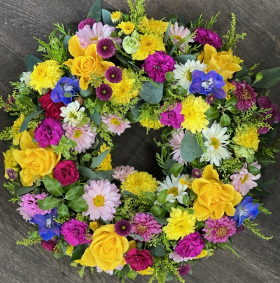 Wreath bright - This vibrant wreath bursts with lively colours, combining bold yellows, rich purples, deep reds and cerise, with touches of blue