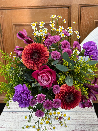 Burst of Brights - A vibrant medley of bright, seasonal flowers bursting with color and personality. Designed to lift spirits and make a statement, each arrangement features a fresh mix of bold blooms and playful textures. Flowers may vary depending on availability, but every bouquet will capture the same joyful, bright aesthetic shown here.