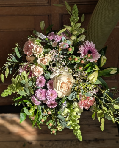 Mother's Day meadow - Soft, romantic and beautifully styled, this arrangement blends pale pink and blush tones with touches of fresh green for a naturally elegant finish. A classic creamy centrepiece bloom draws the eye, complemented by delicate pastel clusters, sculpted petals and playful pops of soft pink detail. Varied textures — from rounded, full blossoms to taller, structured stems — create depth and a graceful, flowing shape.

Designed to feel luxurious yet heartfelt, this bouquet makes a stunning statement while still capturing that gentle, thoughtful sentiment perfect for Mother’s Day gifting.

Please note: stems and varieties may vary depending on seasonal availability, but the overall colour palette, style and value will always be maintained.